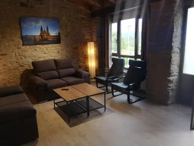 a living room with a couch and chairs and a table at Casa Rural Camino Real in Melide