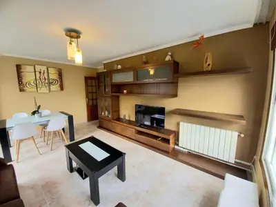 a living room with a table and a fireplace at Piso completo en Camiño Inglés - Sigüeiro, in Sigüeiro