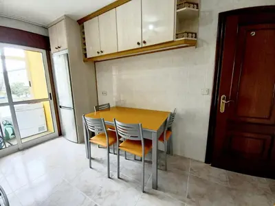 a kitchen with a table and chairs in a room at Piso completo en Camiño Inglés - Sigüeiro, in Sigüeiro