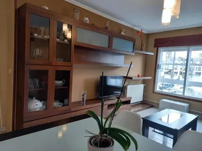 a living room with a table and a television at Piso completo en Camiño Inglés - Sigüeiro, in Sigüeiro