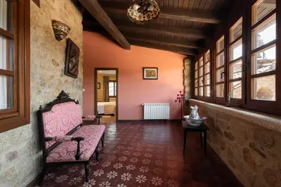 a room with a pink couch and windows at Pazo de Moreda in Sober