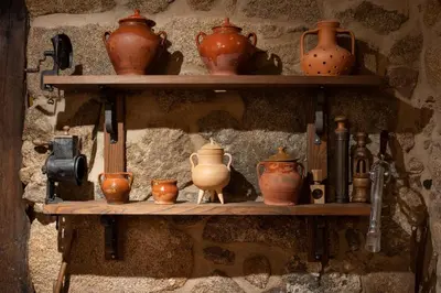 a shelf with vases and other pottery on it at Pazo de Moreda in Sober
