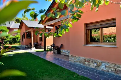 a house with a patio and a yard at Lares · Cabañas Rurales in Las Médulas
