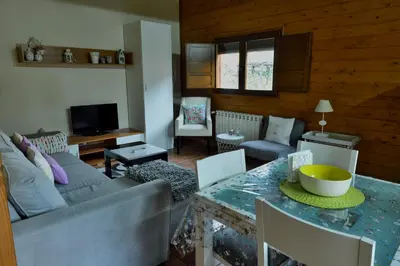 a living room with a couch and a table at Lares · Cabañas Rurales in Las Médulas
