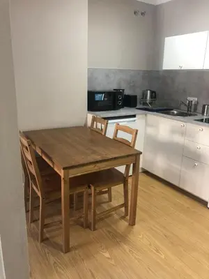 a wooden table and chairs in a kitchen at ESTUDIO Zona Norte Santiago de Compostela VUTCO-04046 in Santiago de Compostela
