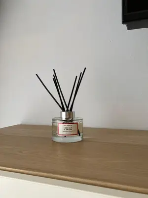 a candleholder with sticks in it sitting on a table at Lemos Mar in Monforte de Lemos