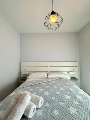 a bedroom with a bed with towels on it at Lemos Mar in Monforte de Lemos