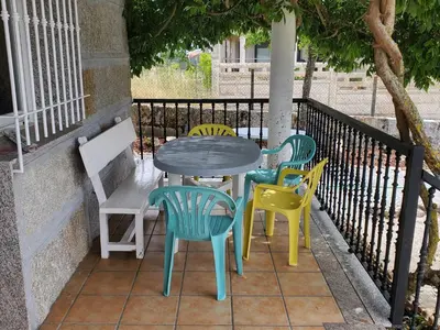 a table and chairs sitting next to a fence at Villa Peregrina in Ourense
