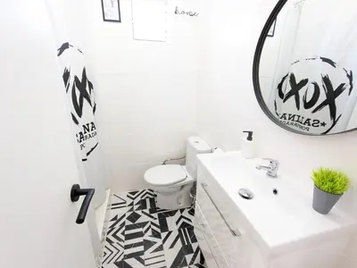 a bathroom with a white sink and a mirror at XOXO - Salinas in Ponferrada