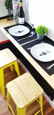 a table with two white plates and two stools at XOXO - Salinas in Ponferrada