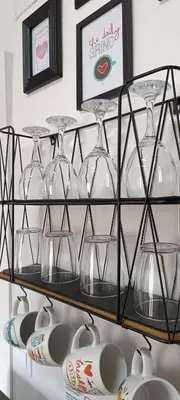 a shelf with wine glasses and plates on it at XOXO - Salinas in Ponferrada