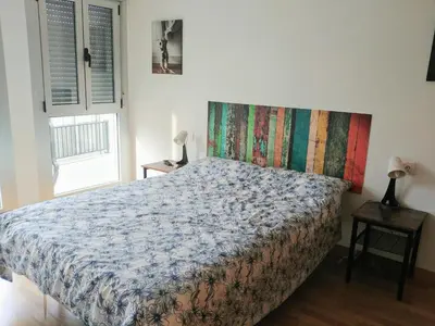 a bedroom with a bed with a colorful blanket at Viveiro Centro in Viveiro