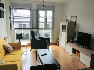 a living room with a couch and a tv at Viveiro Centro in Viveiro
