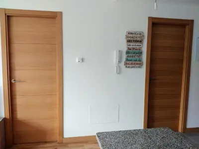 a room with two wooden doors and a wall at Viveiro Centro in Viveiro