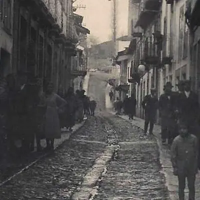 a group of people walking down a city street at Casa Taboada in Sarria