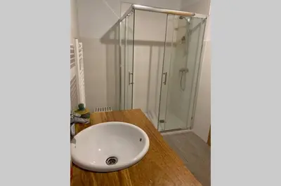 a bathroom with a sink and a glass shower at Casa Rural en Valadouro Serra do Xistral Lugo En medio de la Naturaleza in Lagoa
