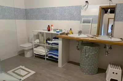 a bathroom with two sinks and a toilet at Casa Rural en Valadouro Serra do Xistral Lugo En medio de la Naturaleza in Lagoa