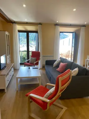 a living room with a couch and a table at Tu&Mi Villafranca in Villafranca del Bierzo