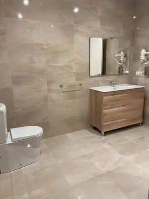 a bathroom with a sink and a toilet and a mirror at Tu&Mi Villafranca in Villafranca del Bierzo