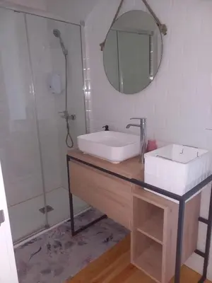 a bathroom with a sink and a mirror at Pensión O Corazón da Ribeira Sacra in La Teijeira