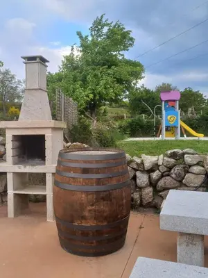 a wooden barrel sitting next to a brick oven at Pensión O Corazón da Ribeira Sacra in La Teijeira