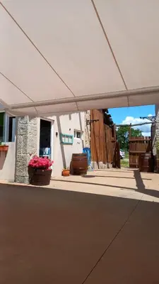 a white tent with flowers on a patio at Pensión O Corazón da Ribeira Sacra in La Teijeira