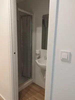 a bathroom with a shower and a sink at Ecorooms SCQ estación in Santiago de Compostela