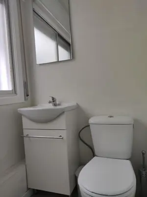 a white bathroom with a toilet and a sink at Ecorooms SCQ estación in Santiago de Compostela
