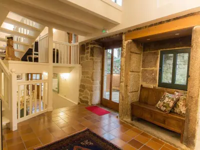 a large living room with a stone wall at Mansion in Cerdedo with Private Pool and Garden in Cerdedo