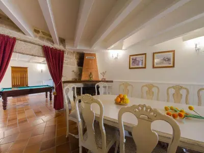a kitchen with a table and chairs and a pool table at Mansion in Cerdedo with Private Pool and Garden in Cerdedo
