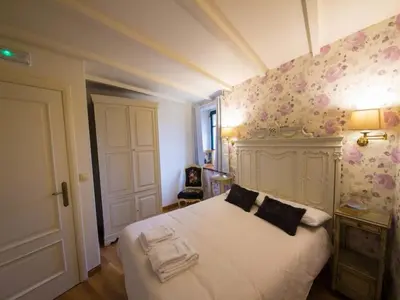 a bedroom with a white bed with flowers on the wall at Mansion in Cerdedo with Private Pool and Garden in Cerdedo