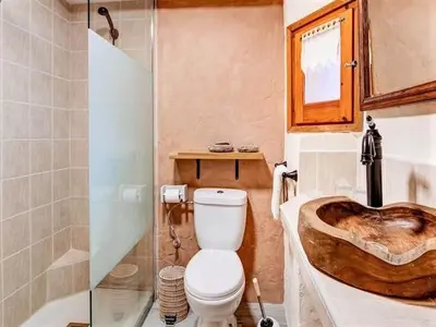 a bathroom with a toilet and a wooden sink at Mansion in Cerdedo with Private Pool and Garden in Cerdedo