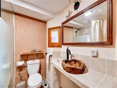 a bathroom with a toilet and a sink with a mirror at Mansion in Cerdedo with Private Pool and Garden in Cerdedo