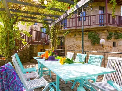 a blue table and chairs on a patio at Mansion in Cerdedo with Private Pool and Garden in Cerdedo