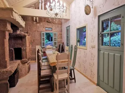 a dining room with a table and chairs and a brick wall at Villa in A Lama near Rías Baixas Beaches in A Lama