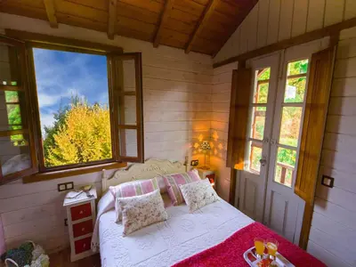 a bedroom with a bed in a room with windows at Villa in A Lama near Rías Baixas Beaches in A Lama
