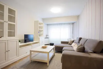 a living room with a couch and a table at Adeinés Viviendas uso turístico medio in A Estrada