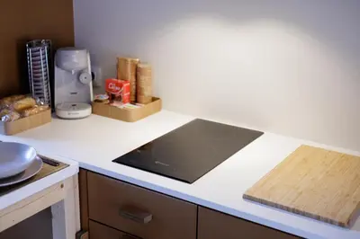 a kitchen with a counter top with a stove top at Adeinés Viviendas uso turístico in A Estrada