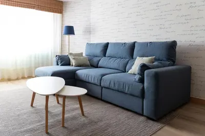 a blue couch in a living room with a table at Adeinés Viviendas uso turístico in A Estrada