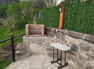 a bench sitting on top of a stone wall at A Casiña do Xastre in Pontevedra