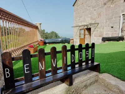 a wooden bench with the words newswick written on it at A Casiña do Xastre in Pontevedra