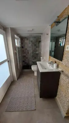a bathroom with a sink and a toilet and a mirror at A Casiña do Xastre in Pontevedra