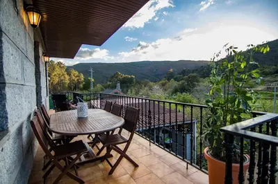 a patio with a table and chairs on a balcony at Casa Charo Prexigueiro in Ribadavia