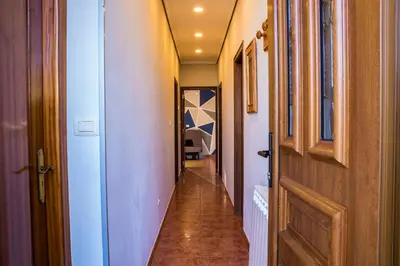 a long hallway with a door and a hallway sidx sidx at Casa Charo Prexigueiro in Ribadavia
