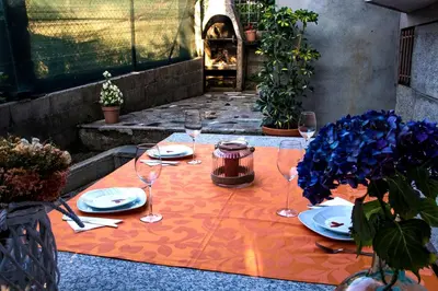 a table with plates and wine glasses on it at Casa Charo Prexigueiro in Ribadavia