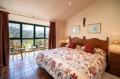 a bedroom with a bed and a large window at Villa Ponte Bora in Pontevedra