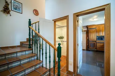 a staircase in a home with a door leading to a kitchen at Villa Ponte Bora in Pontevedra