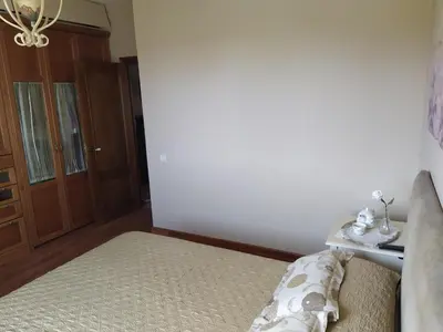 a bedroom with a bed with a couch and a table at O abeiro de Buscalte in Roupar