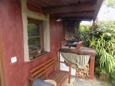 a porch of a house with a bench and a window at Cabaña Bioxana in Molejón