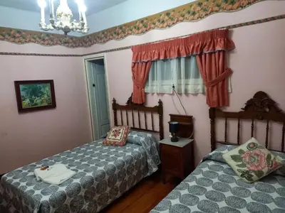 a bedroom with two beds and a window at EL BORDON DE LA CASA BATALLON in Sarria